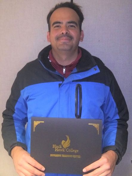 Gilfredo Miranda smiling at camera & holding certificate