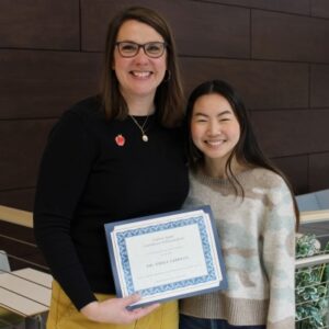 Dr. Emily Lehman holding certificate and Abby Sancken