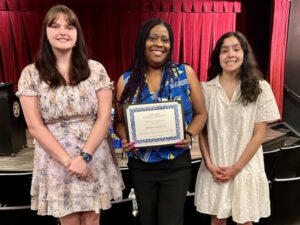 Torria Norman holding certificate flanked by students Michelle Frerich & Lauren Pena