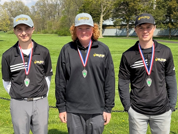 3 golfers wearing medals and smiling at camera