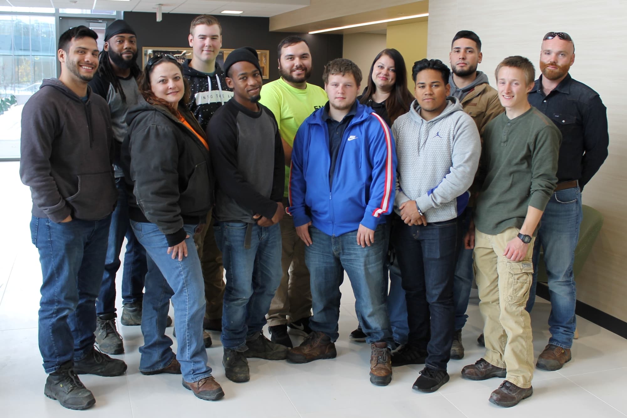 12 people lined up and looking at camera