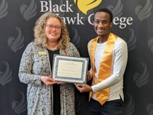 Two people smiling and holding certificate