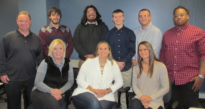 smiling group of 6 men & 3 women