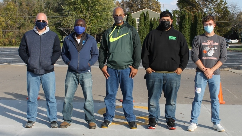 5 people lined up in parking lot