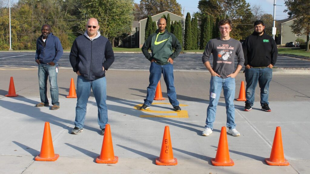 5 people lined up in parking lot