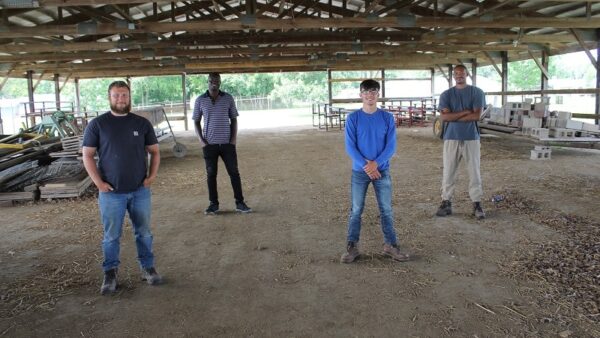 four men standing in a pavilion