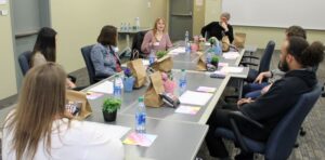 group of people seated talking & having lunch