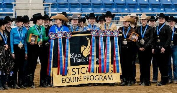 Group of Western riders standing with ribbons & awards