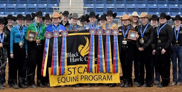 Group of Western riders standing with ribbons & awards