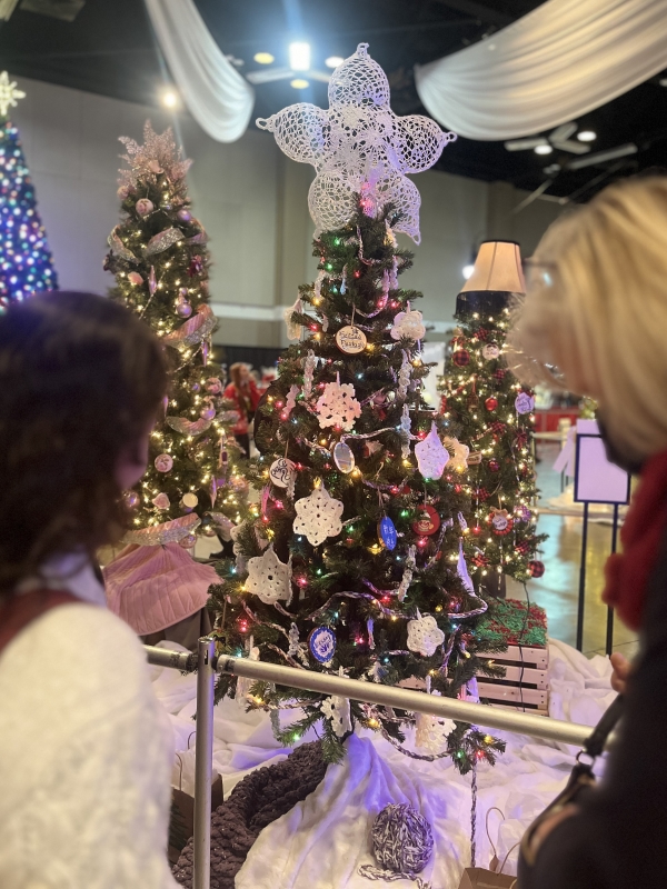 tree decorated with lights and crocheted and handmade ornaments