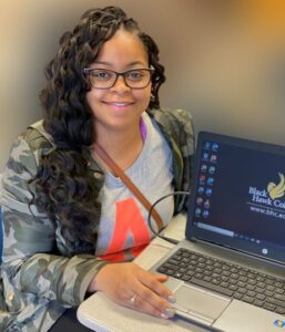 smiling student with laptop