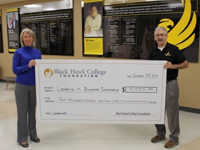 two people holding oversized check