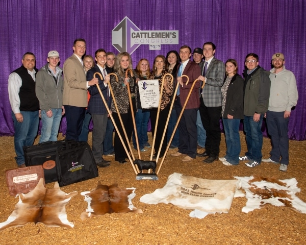 16 people standing with variety of awards