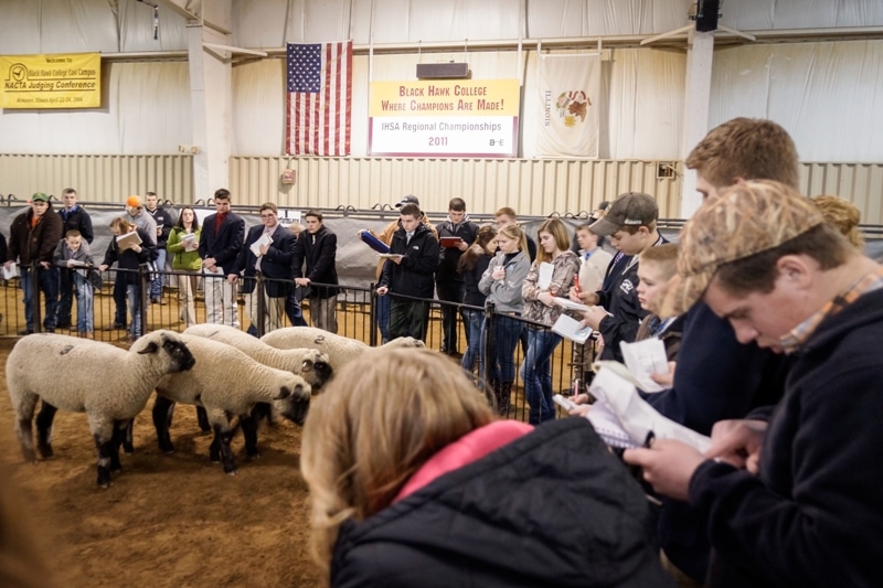 a group of people in a barn