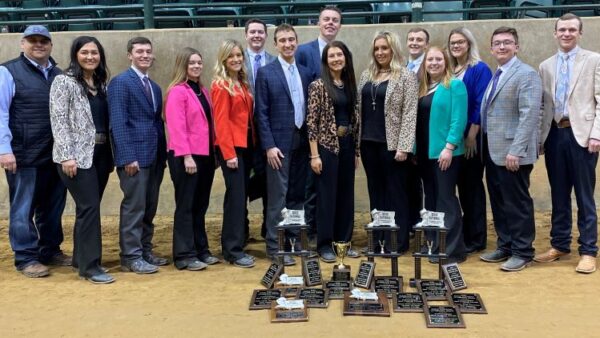 15 people standing with awards on the ground