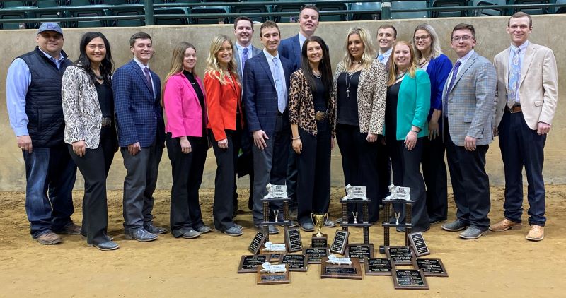 15 people standing with awards on the ground