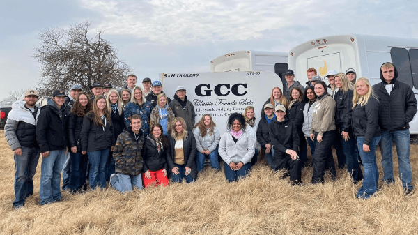 group of college students standing & kneeling outdoors