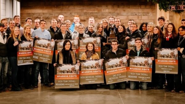 38 people smiling with award banners