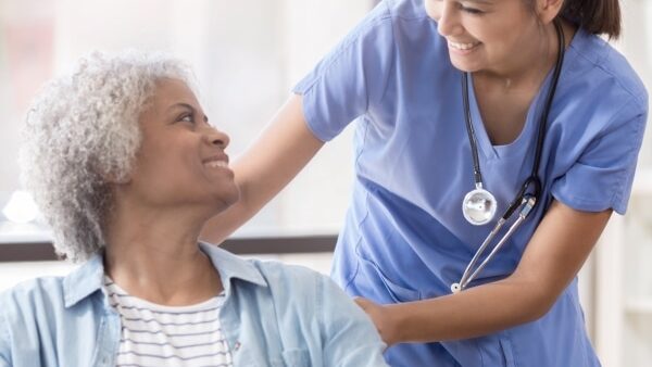 smiling patient and medical assisant