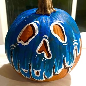 pumpkin with blue melting face painted on it