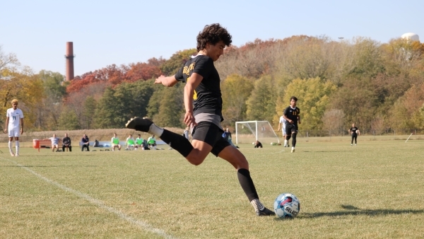 soccer player swinging right leg to kick ball