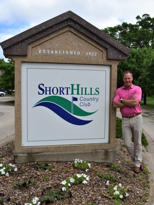 BHC alumnus Mike Downing standing next to Short Hills Country Club sign outside