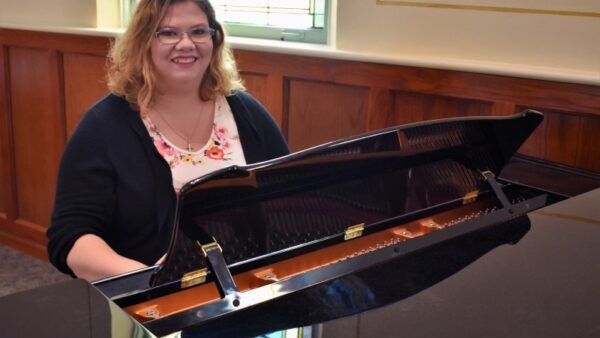 woman sitting at a piano