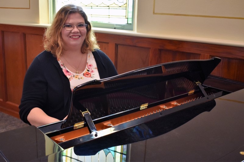 woman sitting at a piano