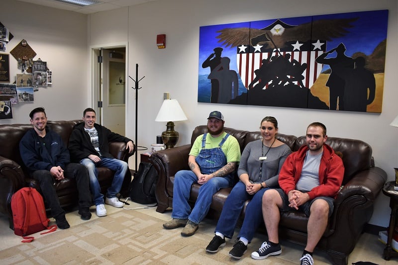 Black Hawk College student veterans sitting on couches in the Veterans Resource Center