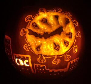 coronavirus carved into a pumpkin