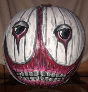 painted pumpkin face with tears and teeth