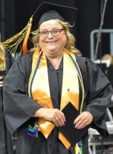 BHC graduate Kristie Amato in her graduation gown, holding her diploma