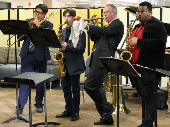 4 jazz musicians playing trombone, sax & trumpet