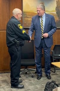 Sgt Pat Clapper and Fritz Larsen shaking hands