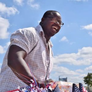 Man smiling against blue sky