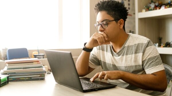 student studying on laptop at home