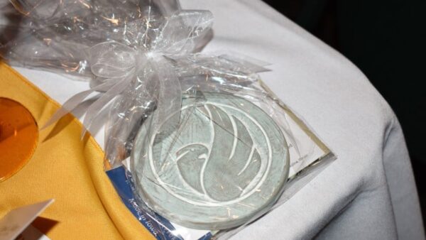 ornament with Black Hawk College logo on a table