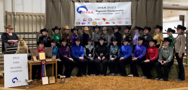 26 people in arena with Regional Championship banner & other awards