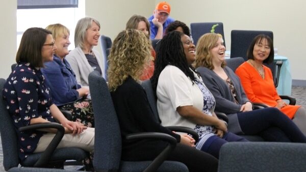 Women's empowerment panelists seated & laughing