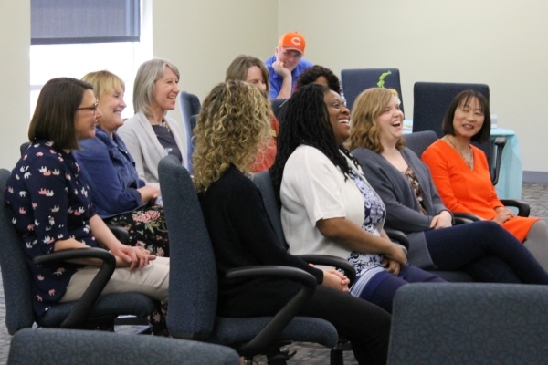 Women's empowerment panelists seated & laughing