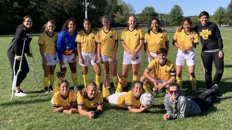 13 women's soccer players and 1 coach