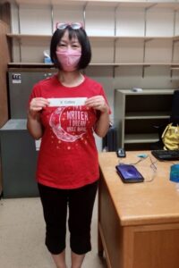 Xixuan Collins wearing mask & standing in her empty office